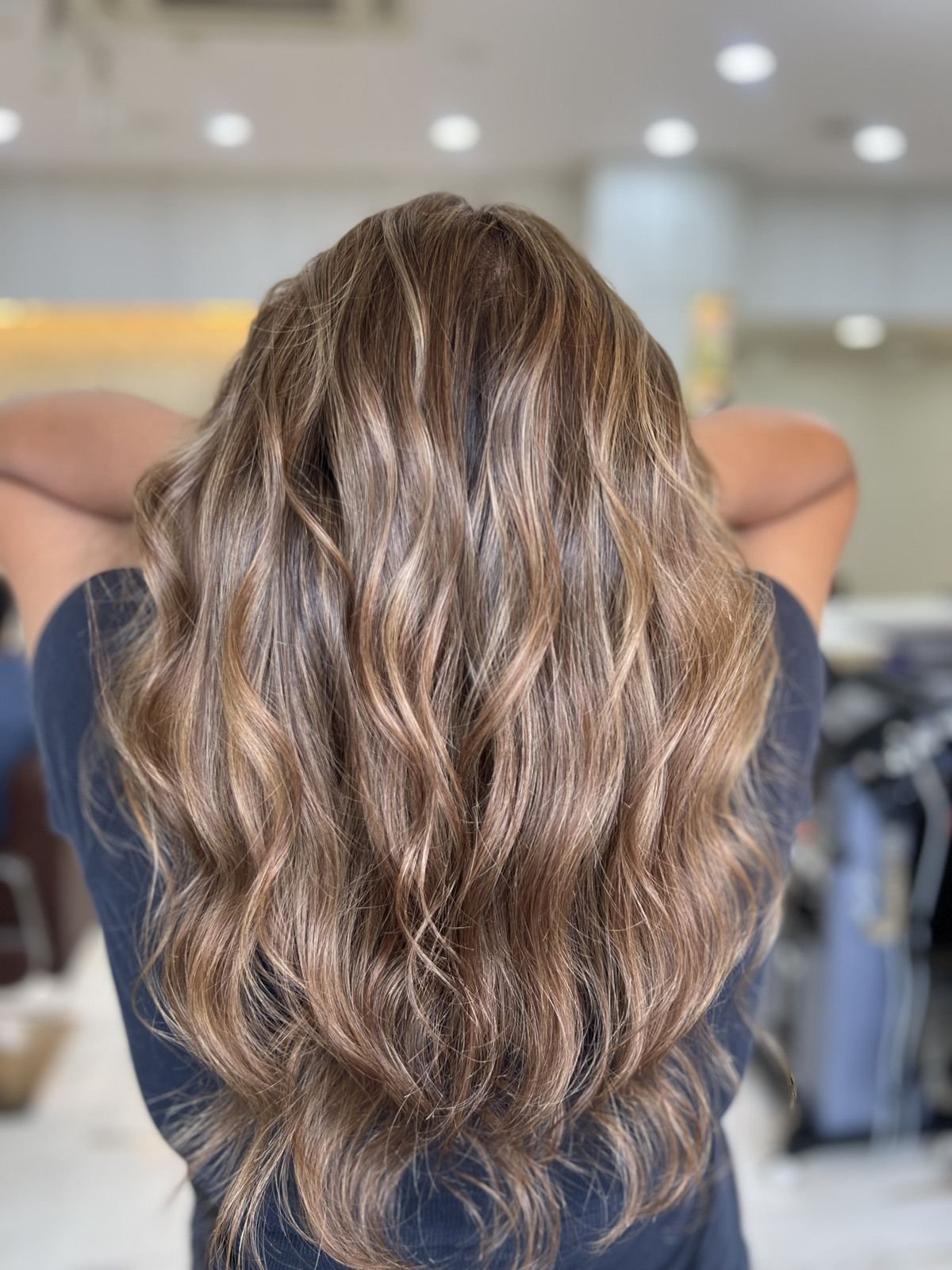Back view of long wavy hair with light brown and blonde balayage