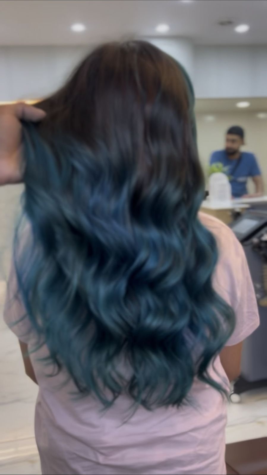 Back view of long wavy dark hair with blue ends