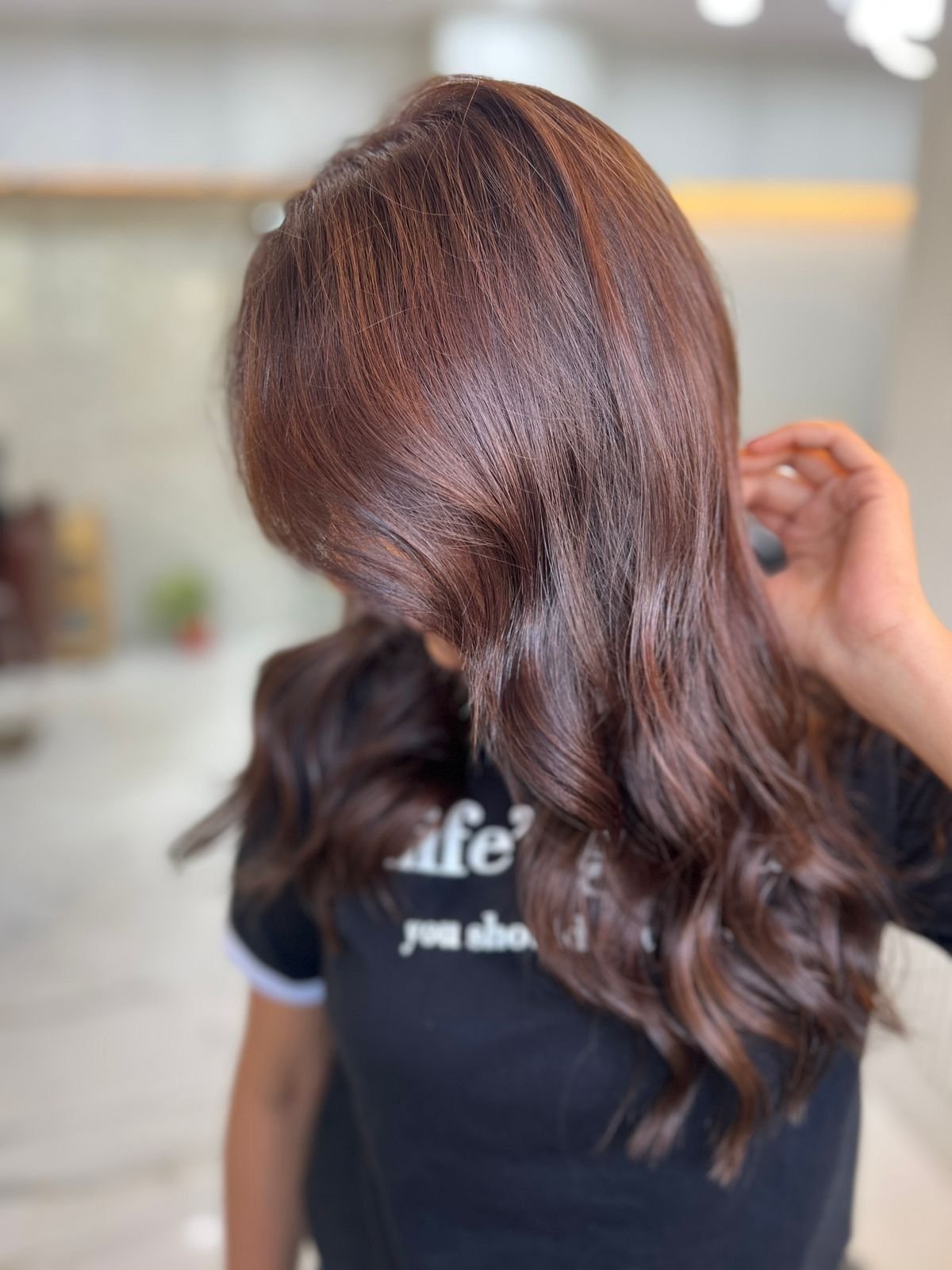 Long wavy hair in warm chestnut brown with caramel tones