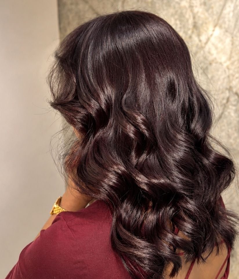Side view of dark brown hair styled in defined curls